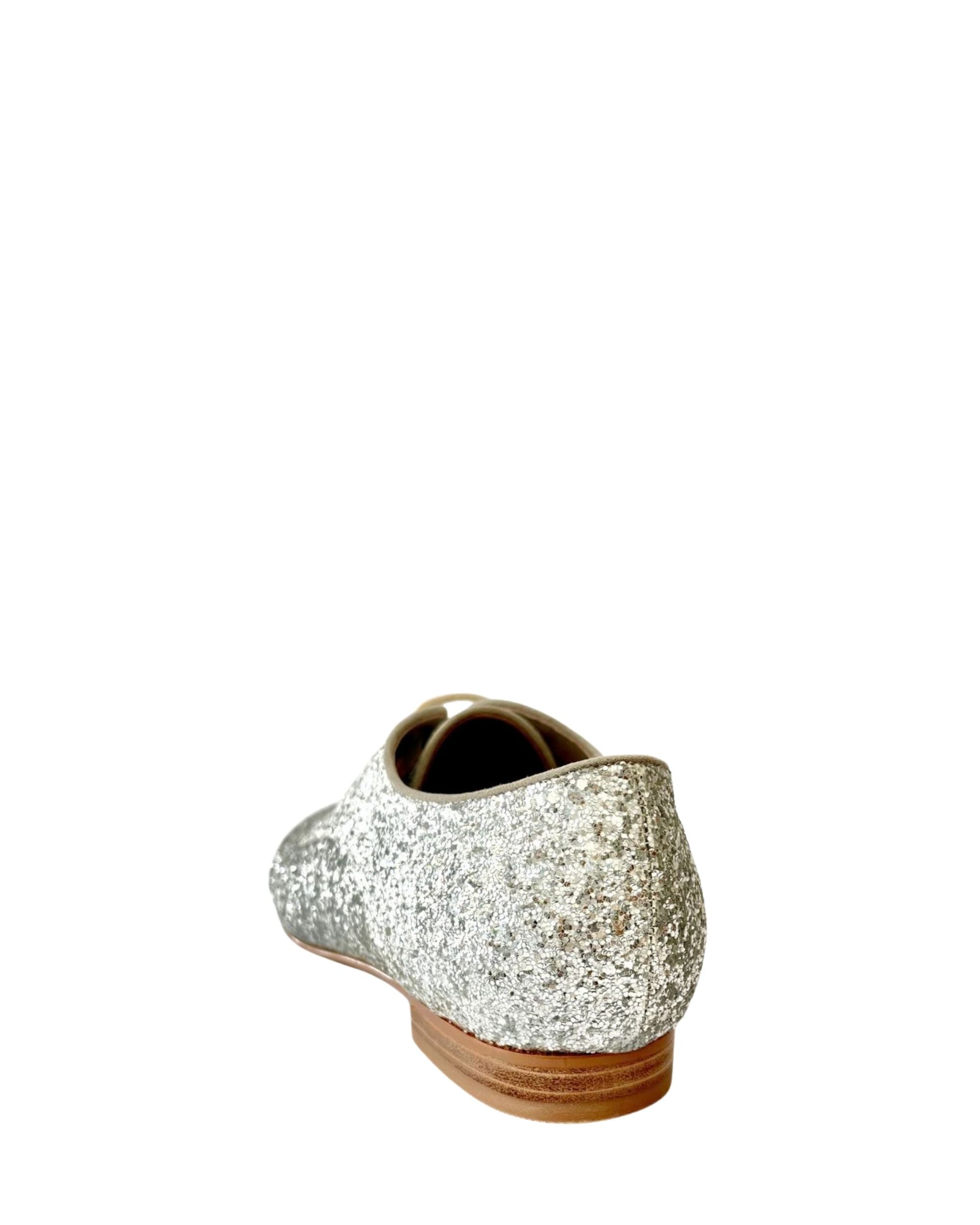 Back view women’s silver glitter leather flat in extended sizes 9–14 by Bohobo